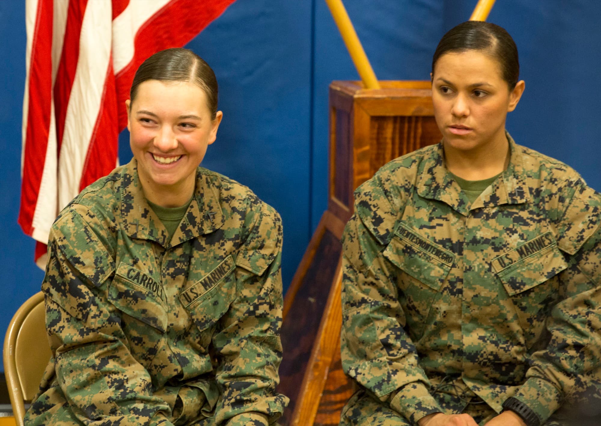 Two women Marines, one White and one Hispanic, after infantry training
