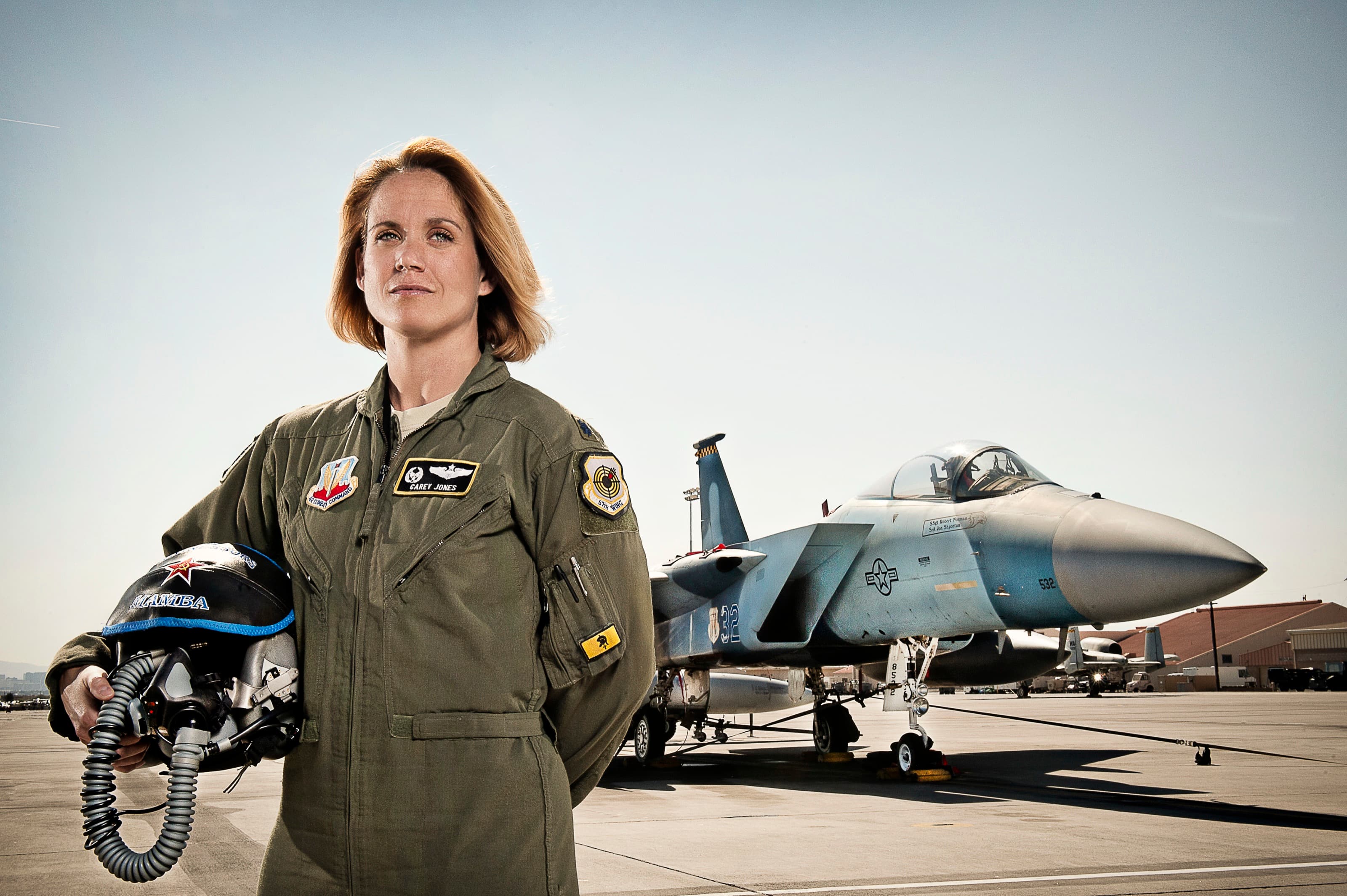A U.S. Air Force fighter pilot standing beside an F-15 Eagle